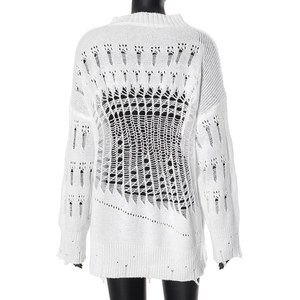Detail of the white distressed knit sweater featuring oversized ripped openwork design