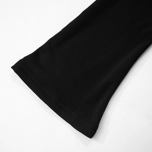 Detail view of double-stitched hem on a black long-sleeve dress with smooth knit fabric