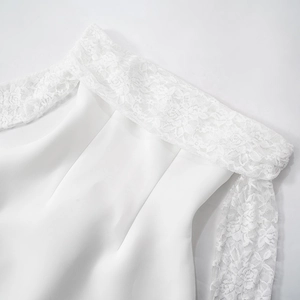 Detail shot of delicate white floral lace neckline on a slim fit long sleeve dress