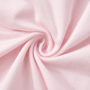 Detailed close-up of light pink knitted fabric texture with soft ribbed pattern