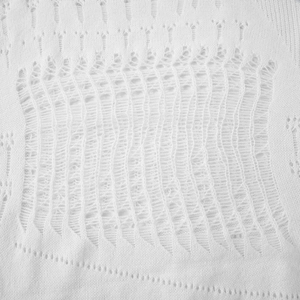 Detail of white hollow-out knitted texture with breathable mesh pattern fabric