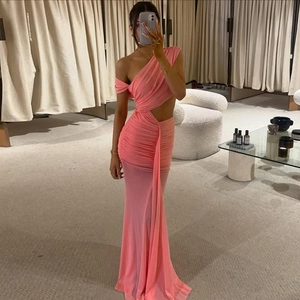 Elegant pink one-shoulder ruched maxi dress with waist cutout and flowing sash detail