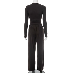 Detail of waist pleated design and wide leg cut on a dark brown long sleeve set
