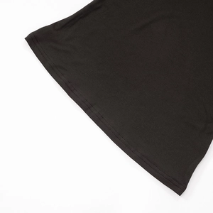 Detailed close-up of double-needle coverstitch hem on black long-sleeve knit lounge set