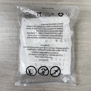 White knitted sweater neatly folded inside a clear plastic zip-lock retail packaging