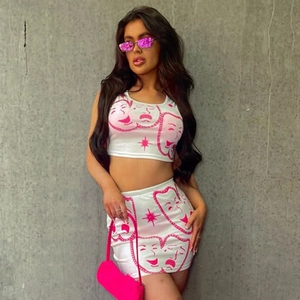 Two-piece street style set featuring a cropped tank top and mini skirt with pink mask prints