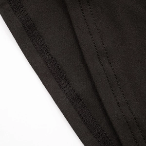 Close-up of premium double-needle stitching on black knit loungewear fabric edges