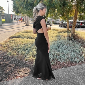 Detail of elegant black slim fit maxi dress with stylish waist cutout and pleated texture