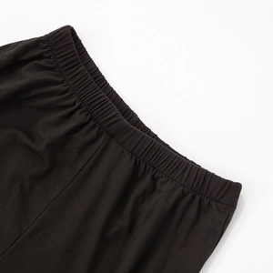 Detailed macro view of the elastic waistband on high-quality black knitted wide-leg pants