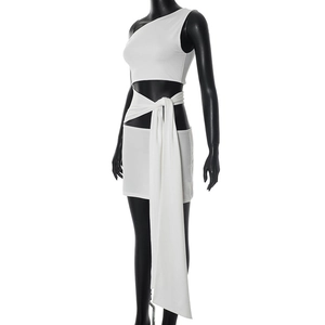Detail of white one-shoulder mini dress with waist tie and draped hem on female mannequin