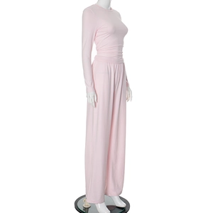 Detail view of pink long sleeve crewneck top and high waist wide leg pants lounge set