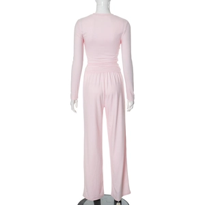 Rear view of light pink long sleeve top and high-waisted wide-leg trousers lounge set