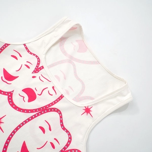 Close-up of white ribbed tank top featuring a pink smile face print and neckline detail