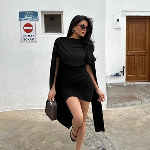 Detail of a black bodycon mini dress featuring elegant draped long shawl sleeves