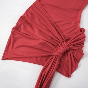 Détail de la robe en tricot rouge montrant les fronces et le nœud croisé complexe
