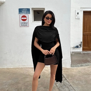 Detail of a black bodycon dress featuring a cowl neck and unique cape-style sleeve design