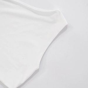 Close-up of white knitted fabric detail showing smooth texture and armhole stitching