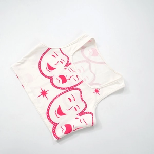 Detail of white ribbed crop top with pink comedy mask print and silver sequins
