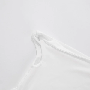 Detailed close-up of white off-shoulder dress featuring a stylish shoulder knot design