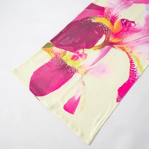 Detail of floral print top with pink iris pattern and premium stitching on yellow fabric