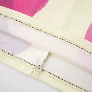 Macro view of precise stitching and vibrant floral print on elegant summer set fabric