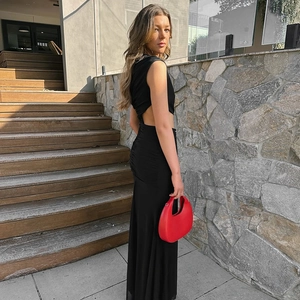 Detail of elegant black sleeveless maxi dress with waist cut-out and side ruching