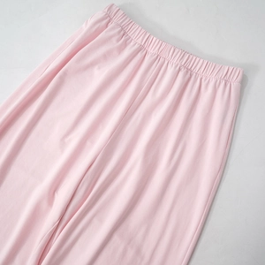 Detailed view of wide elastic waistband on light pink wide-leg casual lounge pants