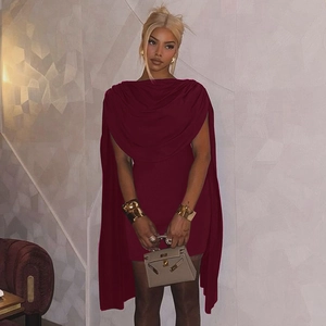 Detail of burgundy cowl neck bodycon dress with cape design for evening party wear