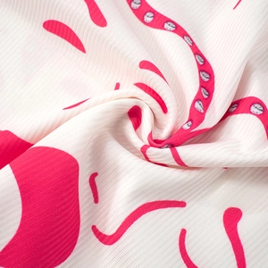 Macro detail of white ribbed fabric featuring vibrant pink octopus tentacle print design