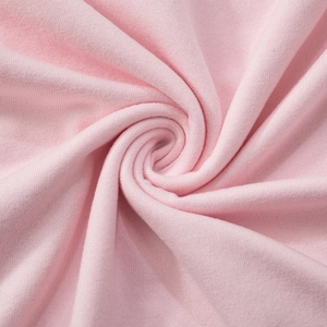 Close-up of soft pink knit fabric texture with elegant draped folds and fine textile detail