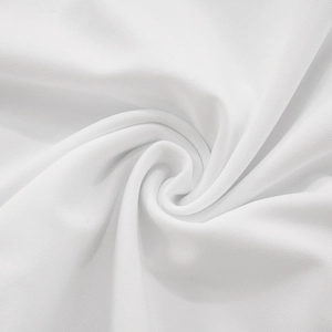 Close-up of white ribbed knit fabric showing fine texture and soft draping quality