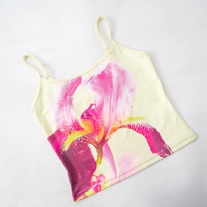 Detail of elegant yellow camisole top featuring large pink and purple floral iris print