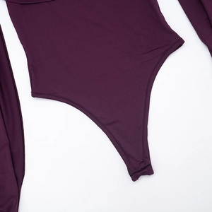 Detail of plum bodysuit featuring snap button closure and high-cut leg with flatlock stitching