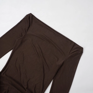 Detailed view of dark brown sheer mesh fabric with elegant off-the-shoulder neckline