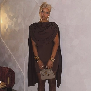 Detail view of coffee brown cowl neck dress with unique cape sleeve design and accessories