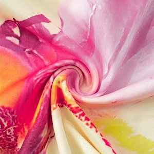 Macro shot of elegant floral print fabric with vibrant colors and silky smooth texture