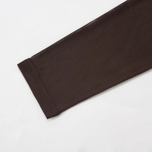Detail of dark brown sheer mesh sleeves with delicate hem stitching on a long dress