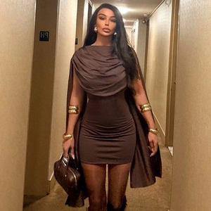 Detail of a dark brown cowl neck bodycon dress paired with a matching long cape