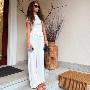 Detail view of white two-piece lounge set with short sleeve t-shirt and wide-leg trousers