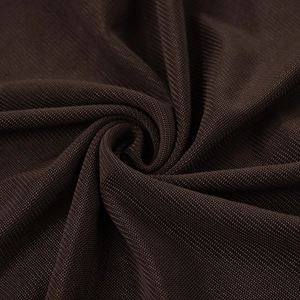 Detail of dark brown sheer mesh fabric texture with fine micro-perforations for dresses