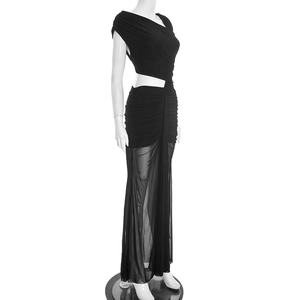 Detail of elegant black slim fit dress featuring waist cutout and pleated textures