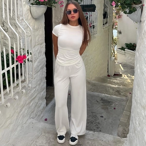 Detail of white high-waist wide-leg pants and slim-fit tee set for summer casual wear