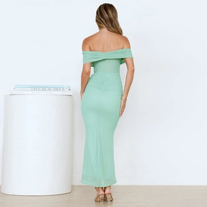 Close-up of the back of light green off-shoulder ruched dress showing fabric detail