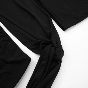 Detail of black off-shoulder dress featuring a knot design and cutout details