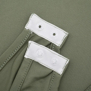Close-up of olive green bodysuit bottom with snap closure and ribbed fabric detail