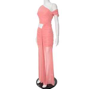 Detail of coral pink ruched dress featuring asymmetric neckline and waist cutout design