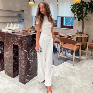 Detail of white long-sleeve top and wide-leg pants set in soft ribbed knit fabric
