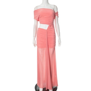 Detail of coral pink pleated maxi dress with one-shoulder design and waist cutout