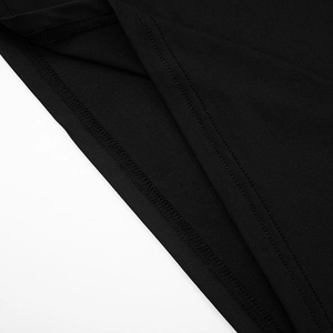 Detail shot of black knit dress hem showing precise double-needle stitching and fabric