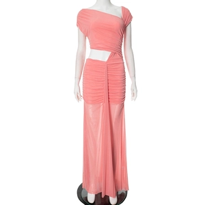 Detail view of coral pink ruched dress with side cutout and sheer mesh skirt